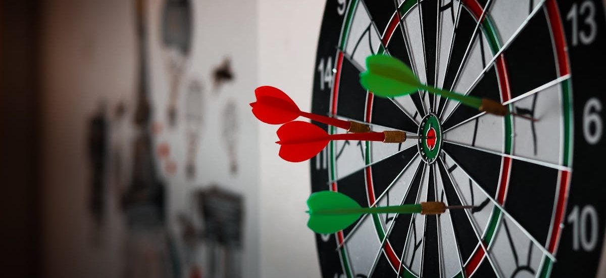 Close-up of a dartboard with multiple darts hitting the target, emphasizing precision and focus.